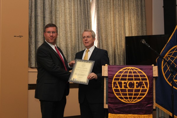 In August, Roger Carpenter (r), chapter president, presents a life member certificate to Maj. Mark Wilson, USAF.